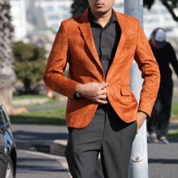 Notched lapel and two-button closure of a luxury custom men's statement sport coat.