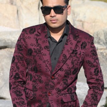Notched lapel and two-button closure of a bespoke men's formal wear jacket.