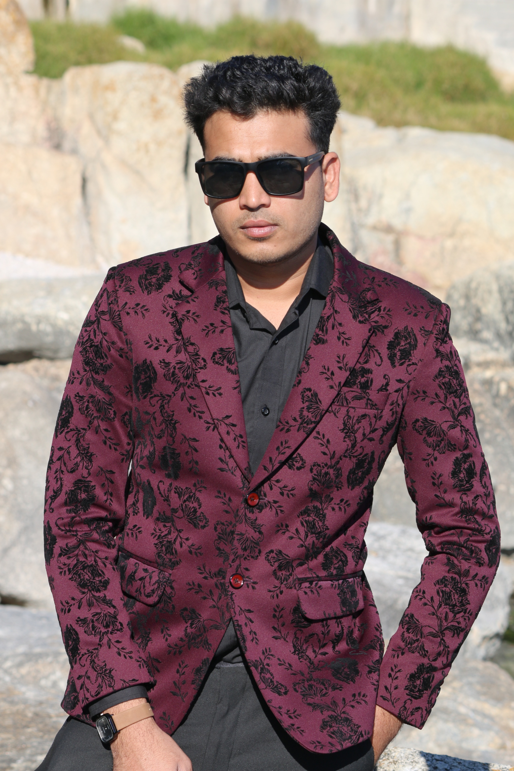 Notched lapel and two-button closure of a bespoke men's formal wear jacket.